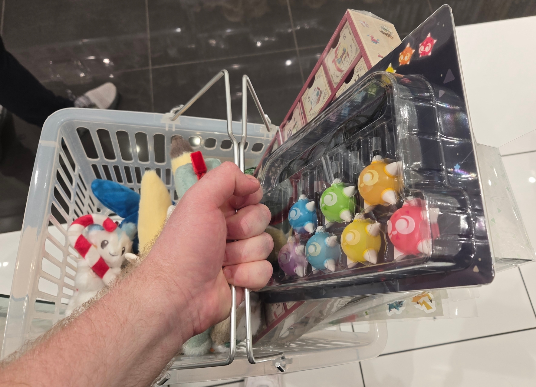 A photo of shopping basket almost-full of Pokemon merch.