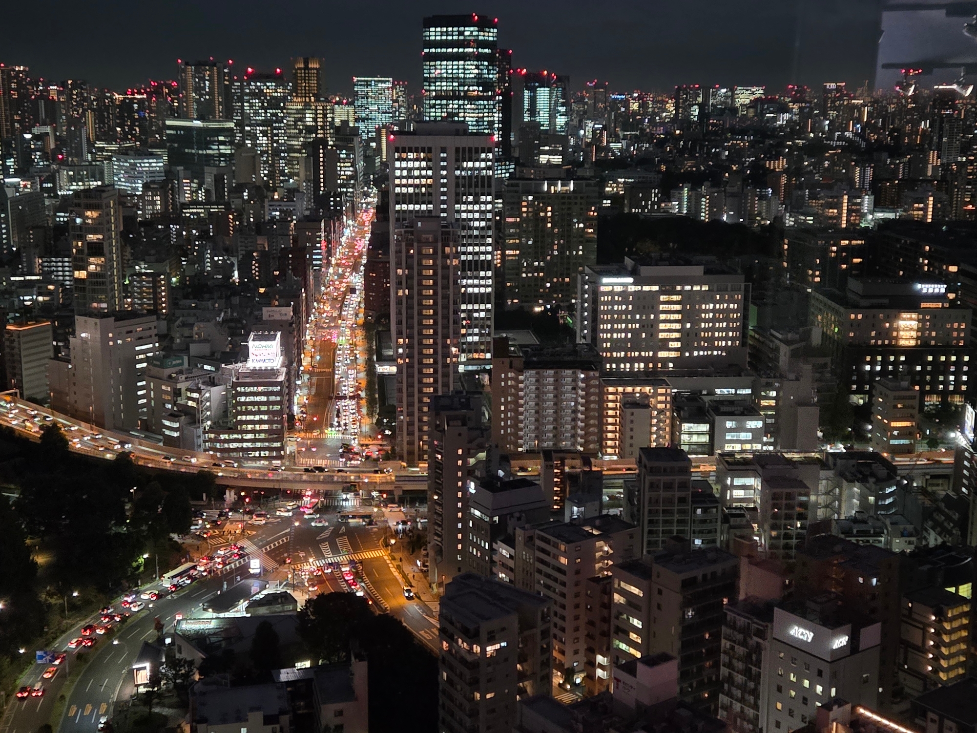 A photo of various parts of Tokyo seen from above, at night.
