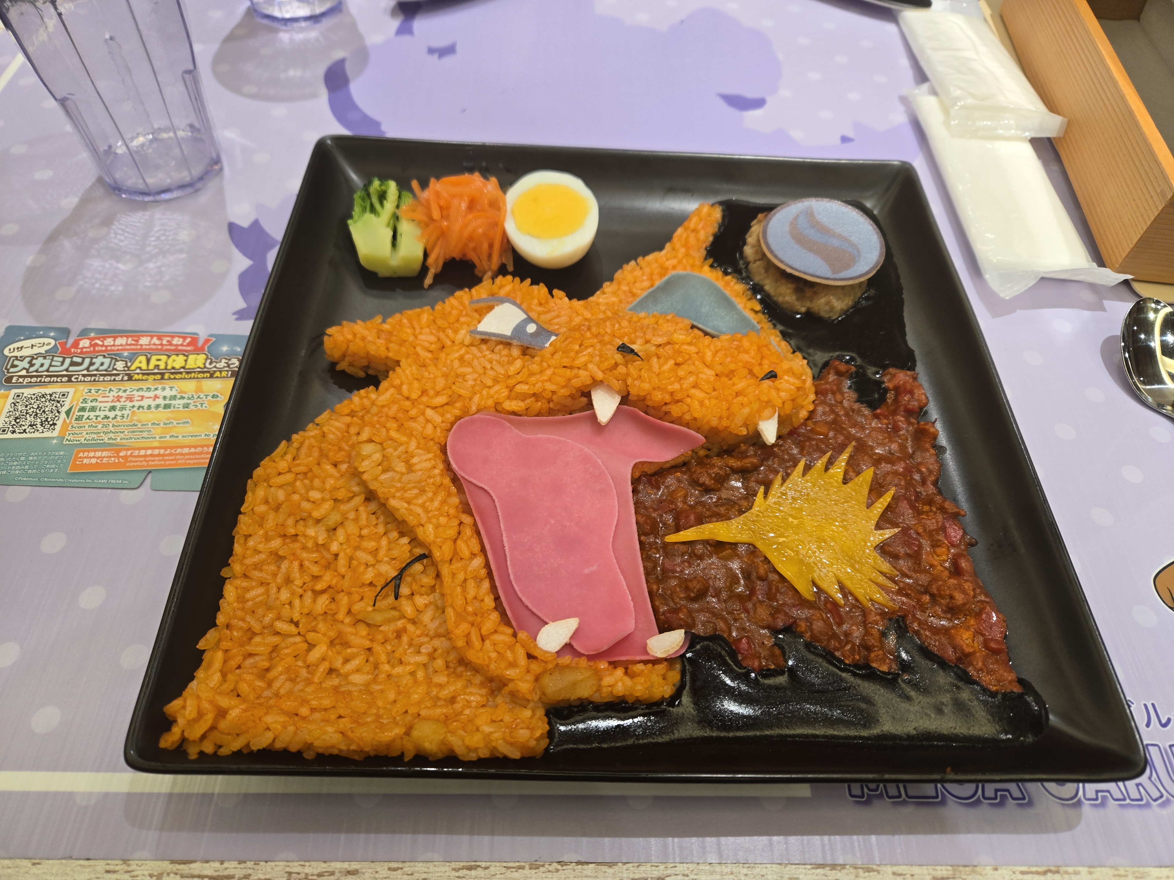 A photo of the augmented-reality Mega Charizard curry. We got given a QR code to scan, which took us to a website, which got us to use the dish as a positioning marker for a mega evolution animation featuring randomly Mega Charizard X or Mega Charizard Y.