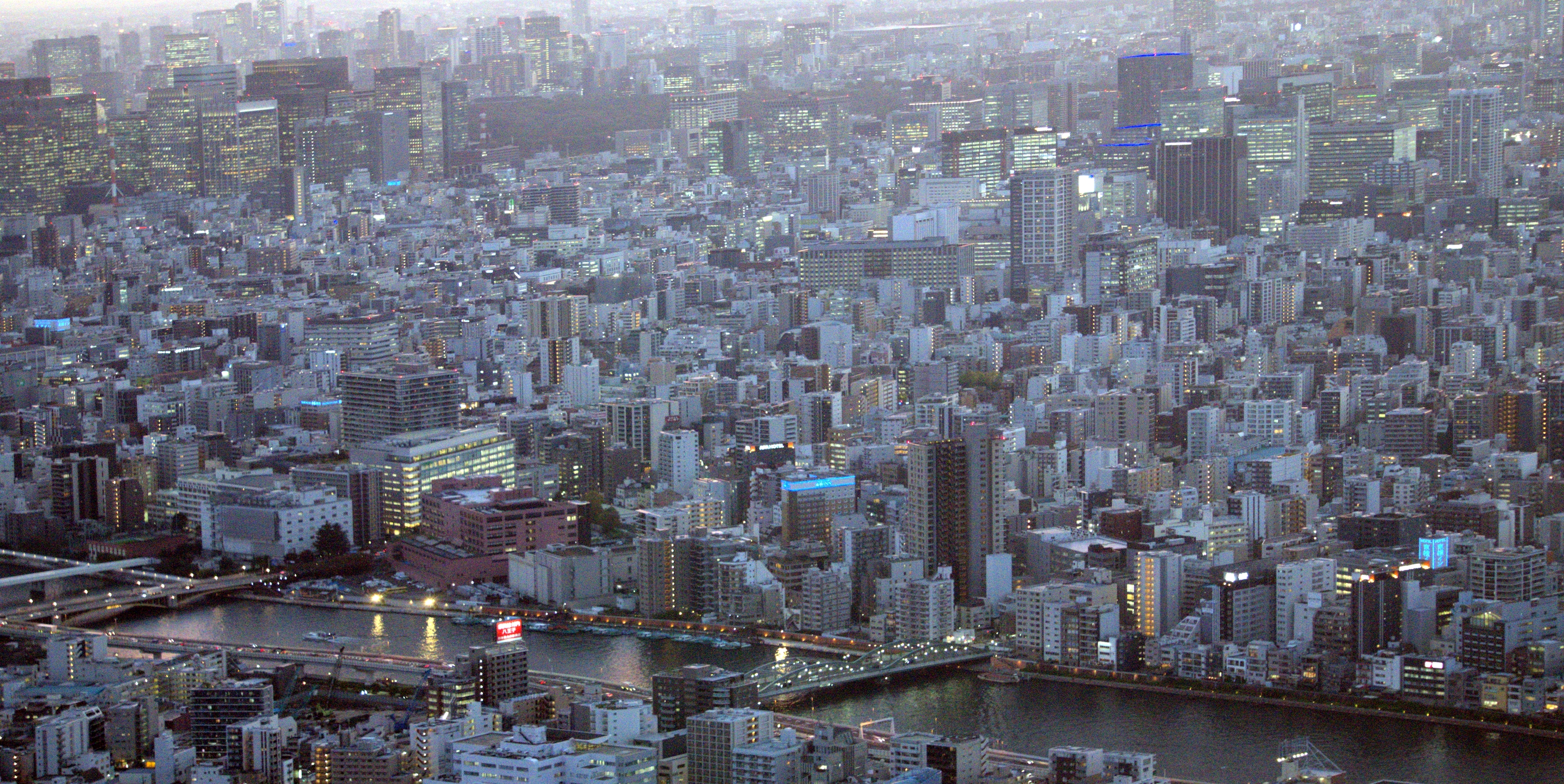 A photo of looking down across a huge view of a metropolitan cityscape.