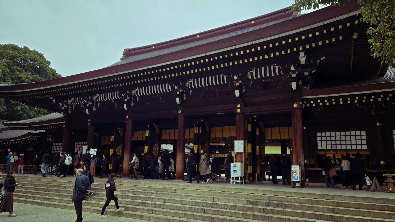A photo of a crowd in front of a large temple building.