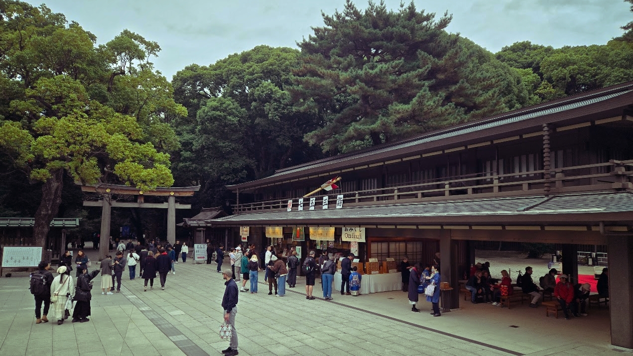 A photo of a crowd in a courtyard near another temple building.