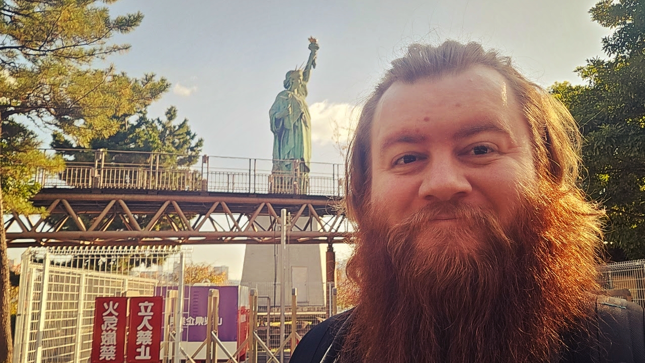 A selfie of me in front of the mini Statue of Liberty. It's still a giant statue!