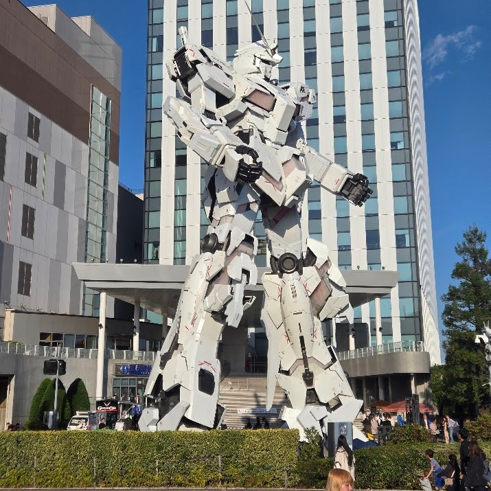 A photo of a large white Gundam statue: the Unicorn Gundam.